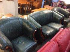 A green leather three piece suite