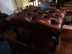 An oxblood leather Chesterfield stool