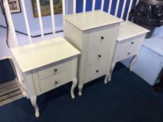 A pair of white bedside drawers and a small three drawer chest