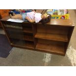 A long teak sliding door bookcase