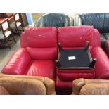 A red leather two seater, with a footstool