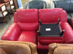 A red leather two seater, with a footstool