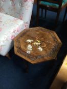 An octagonal occasional table, inlaid with elephants