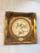 A pair of gilt framed relief plaques