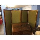 A walnut four fold screen, with green upholstery to one side and tartan fabric to the other, with
