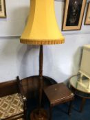 An Oriental carved standard lamp and a small occasional table