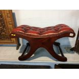 An oxblood Chesterfield stool