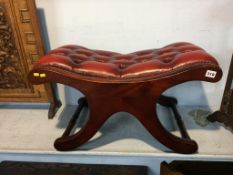 An oxblood Chesterfield stool