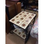 A metal work and tiled tea trolley