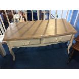 A pale oak top and cream two drawer coffee table