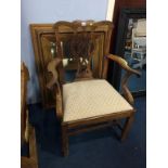 A gilt mirror and a carver chair