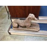 A pair of garden reclining Greyhounds. 70cm high