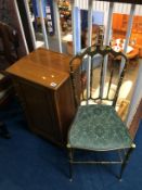 A mahogany bedside cabinet and a brass single chair