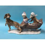 A large Lladro group of two children in a sleigh being pulled by a dog, numbered 5037