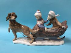 A large Lladro group of two children in a sleigh being pulled by a dog, numbered 5037