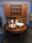 A G Plan circular table and a set of four chairs, with matching wall unit