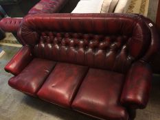 An oxblood Chesterfield three seater settee