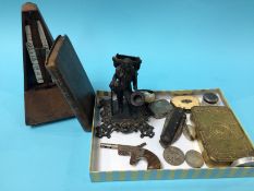 A metronome, World War I tin etc.