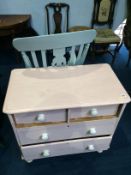 A painted pine chest of drawers and a rocking chair