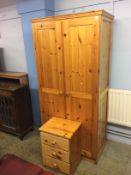 A pine wardrobe and bedside chest