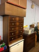 A kitchen cabinet, two ottomans and a walnut chest of drawers