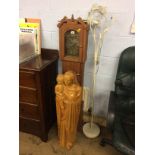 A carved figure group, Mary and child, a clock and a lamp