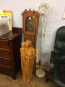 A carved figure group, Mary and child, a clock and a lamp