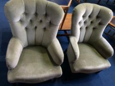 A pair of buttoned easy chairs