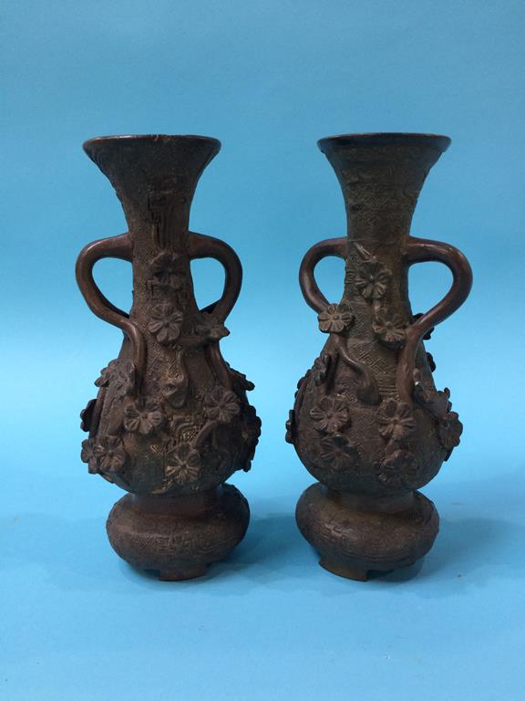 A pair of cast metal spill vases