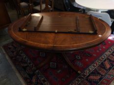 A reproduction mahogany extending dining table