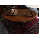 A reproduction mahogany extending dining table