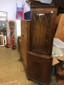 A mahogany corner cabinet