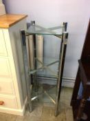 A chrome and glass three tier stand