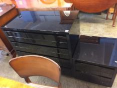 A black high gloss chest of drawers and matching bedside chest