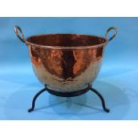 A large copper pot and stand