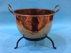 A large copper pot and stand