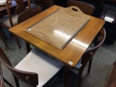 A walnut extending dining table and four chairs