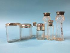A pair of silver mounted spill vases and scent bottles etc.