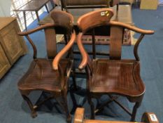A pair of Oriental hardwood corner chairs, with solid seats