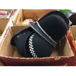 A quantity of police helmets / hats