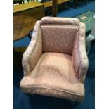 A pink upholstered nursing armchair