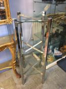 A chrome and glass three tier stand