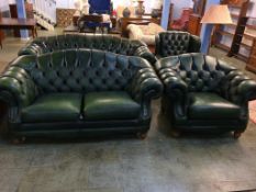 A green Chesterfield style two seater settee and armchair