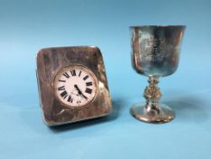 A silver goblet and a silver pocket watch stand