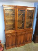 A small yew wood three door breakfront bookcase
