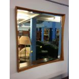 A teak framed mirror