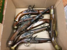 A collection of reproduction flintlock pistols