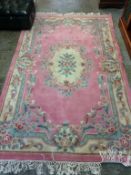 Two pink ground rugs