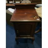 A mahogany bedside cabinet