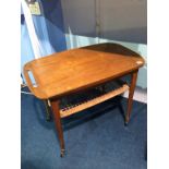 A Danish teak tray top trolley, with rushwork under tier, supported on slender legs. 71cm wide